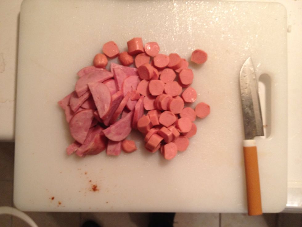 While the oil is heating up or before totally up to you cut the hot dog and sausages into smaller pieces again up to you what size but this is around optimal. Based on what I saw in my grandmas cookin