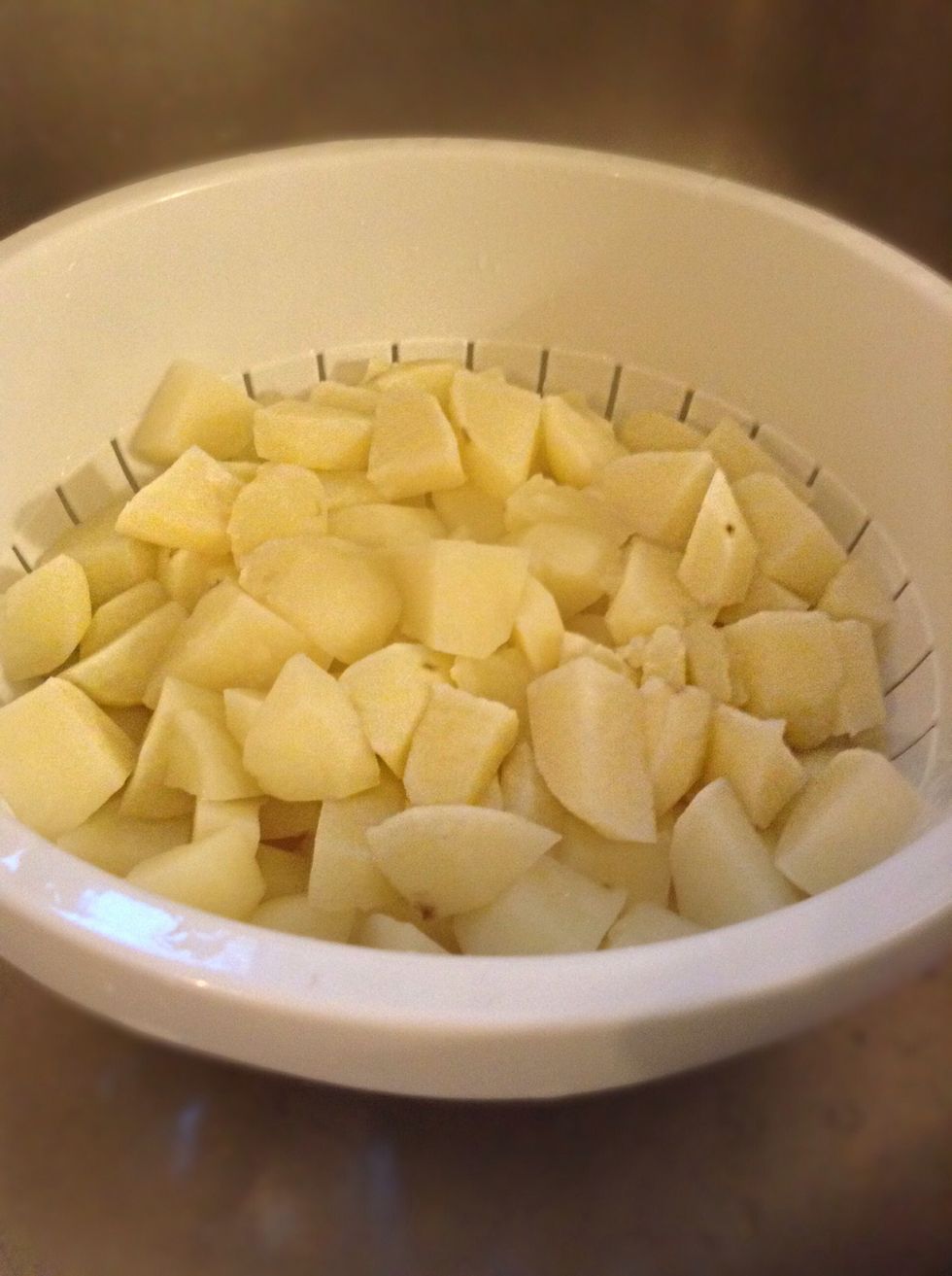 While the onions are cooking your potatoes should be done so its time to drain those bad boys!!