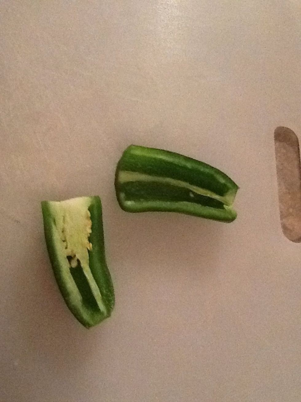 While the onions soften, take care of your jalape\u00f1o. (The more membrane and seeds you leave, the spicier it will be.) Dice it up.