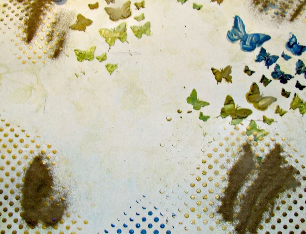 While the paint is still wet I sprinkled on Gold embossing powder and heat set. Because the paint is still wet, the powders will bubble up a bit, but I like this effect, it adds more texture.