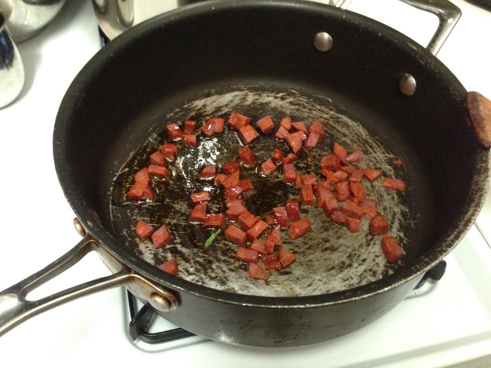 While the pasta boils, heat some olive oil with the chopped chorizo in a pan.