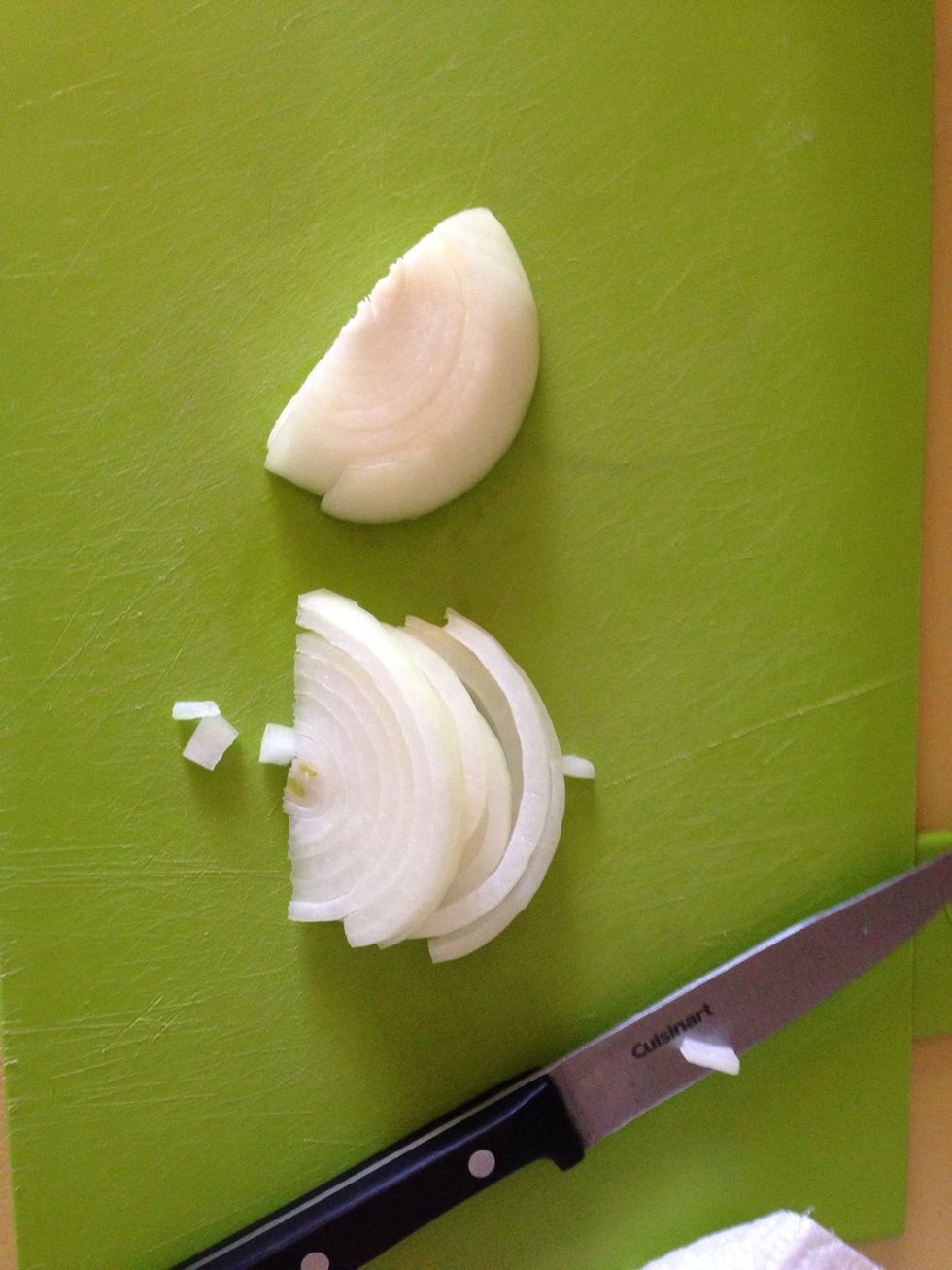 While the pasta cooks according to the package's instructions, slice 1/4 of an onion.