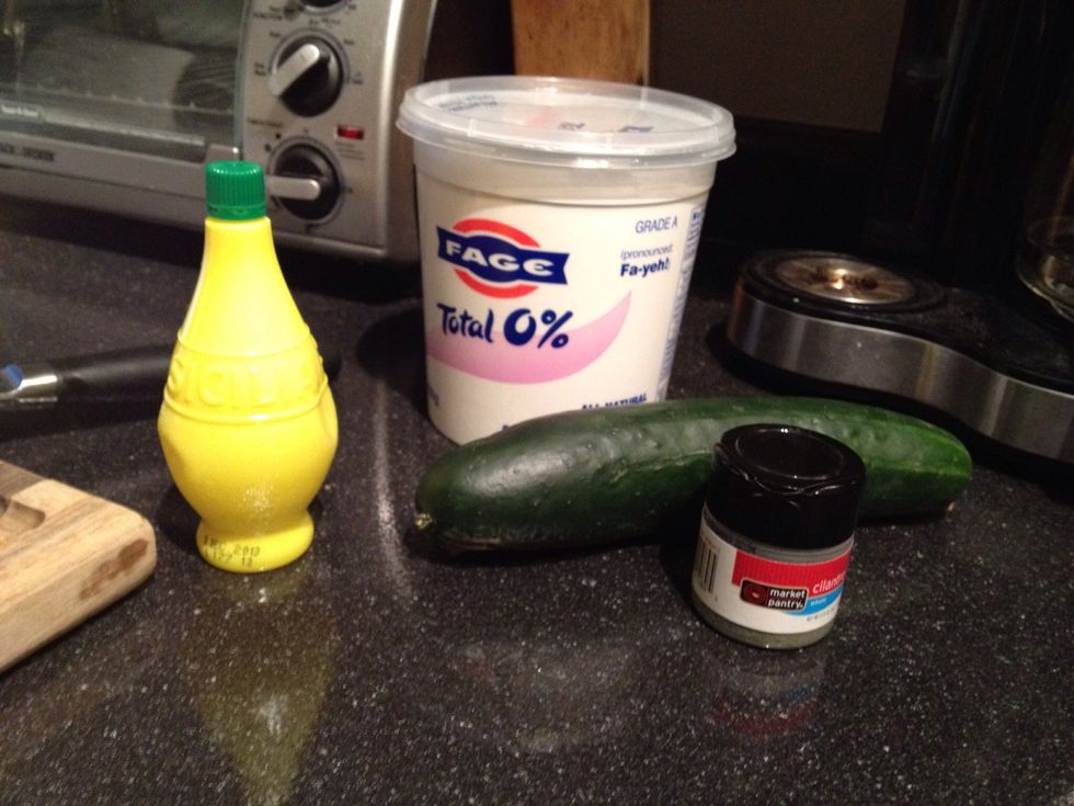 While the patties are baking, lets make the tzatziki! It's really simple. Take your yogurt, lemon juice, and chopped cucumber. Add salt and pepper. Mix together and add fresh dill if you have it.