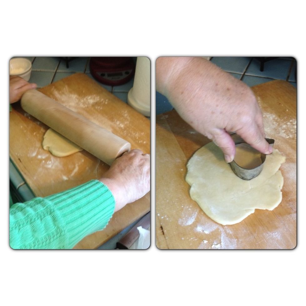 While the pie is cooking I'm making some decorations with some of the left-over pie crust pastry. I roll out the dough and using a pumpkin shaped cookie cutter, cut out a couple pumpkins.