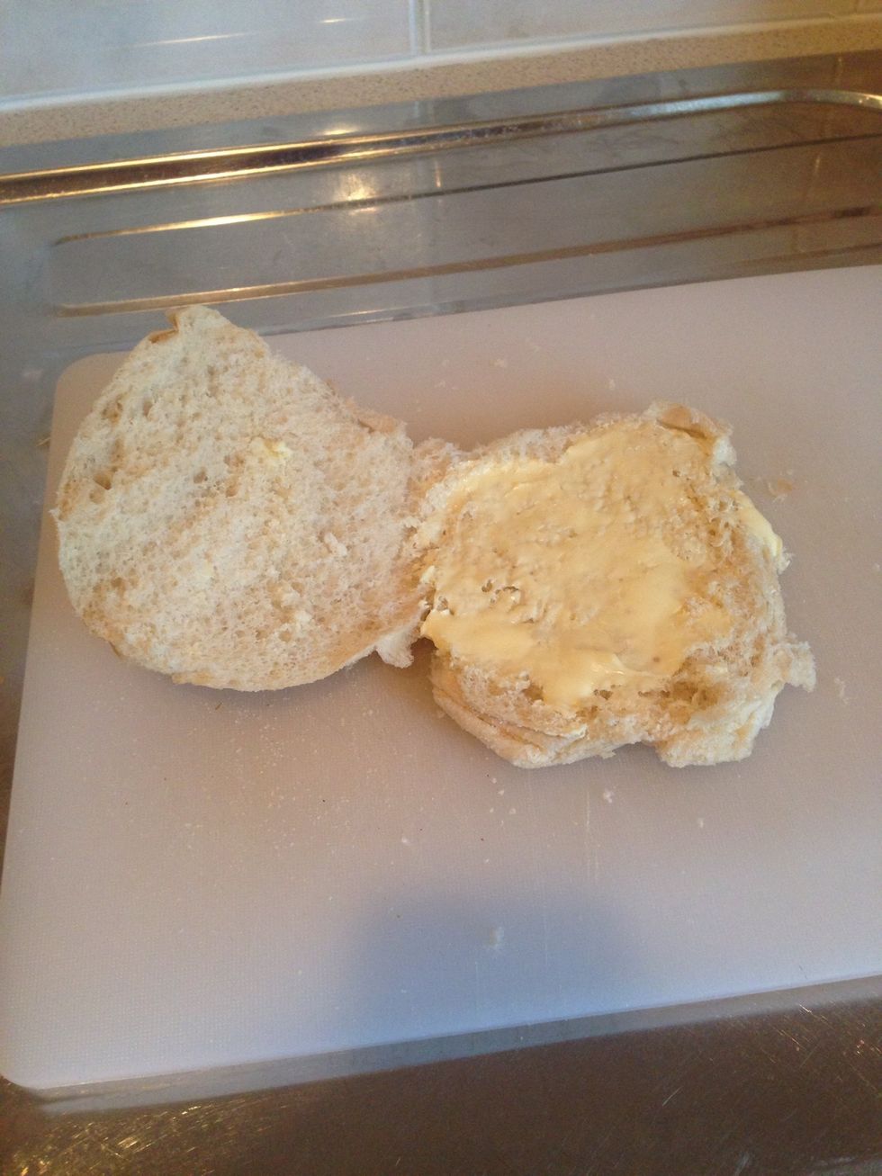 While the pie is heating, open and butter the roll. Be generous with the butter. Should note that this is a soft morning roll, but you can have a hard one if you're so inclined. Oh myyy