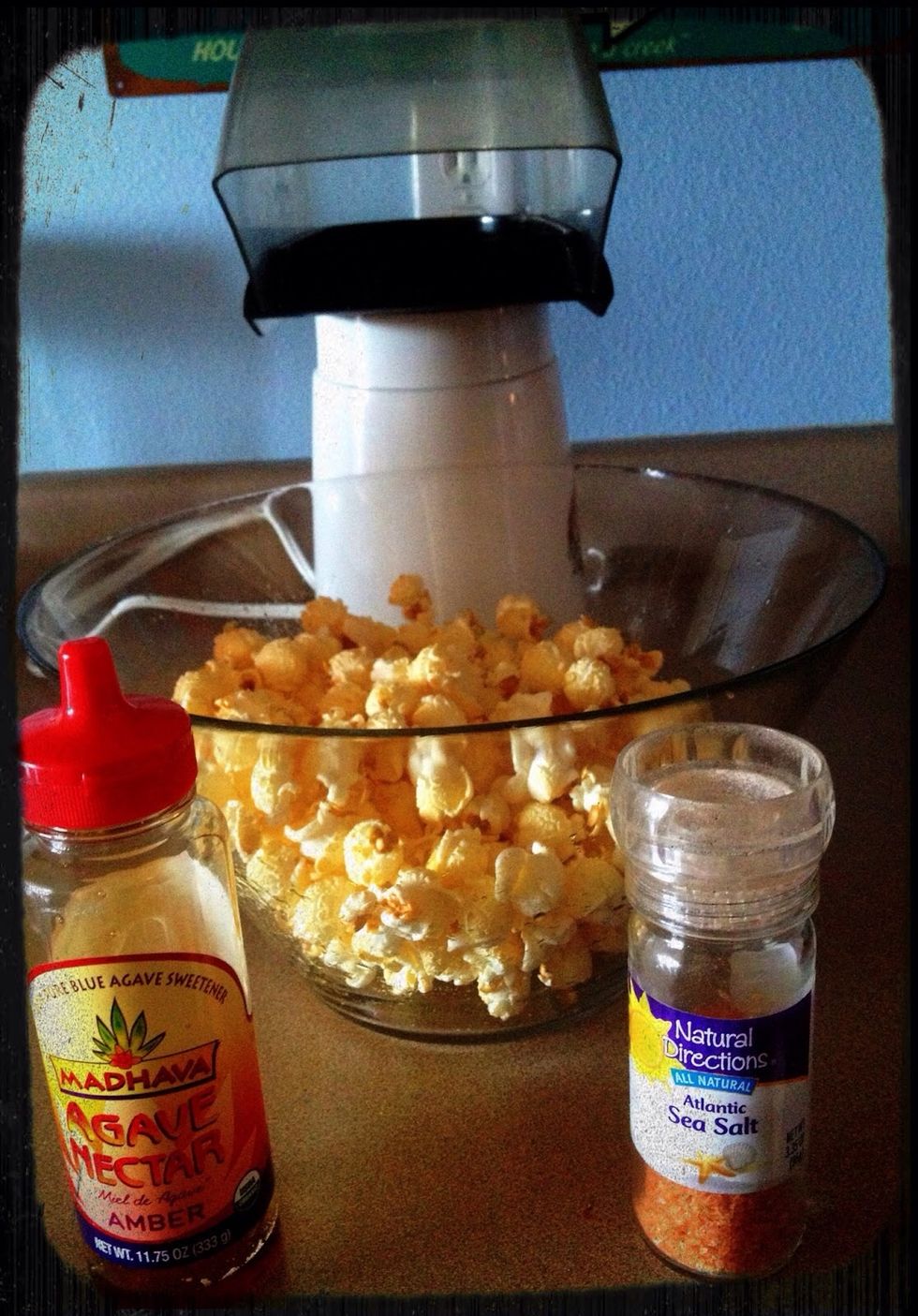 While the popped corn is still hot, add the agave nectar, then the salt. Shake the bowl. This disperses the agave nectar and salt so every piece will be sweet and salty.