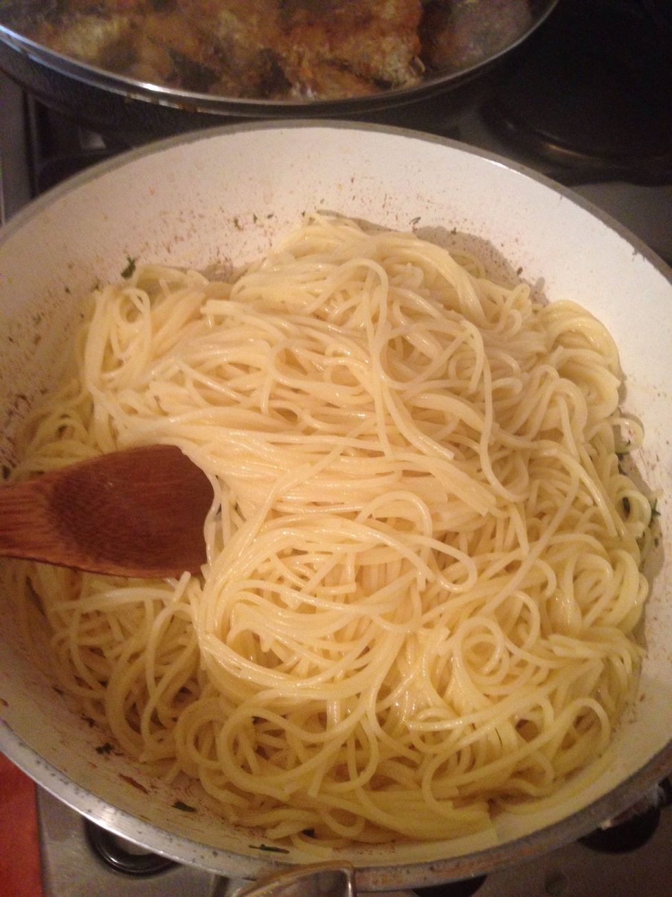 While the sauce is cooking remove cooked spaghetti from water and add 150 gram butter on it