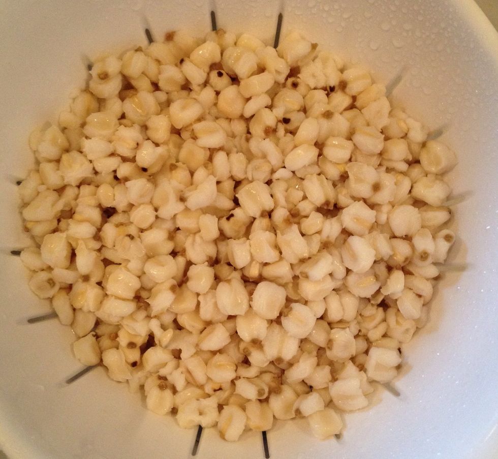 While the stock is coming to a boil, drain and rinse the canned hominy (Juanita's brand is very good).