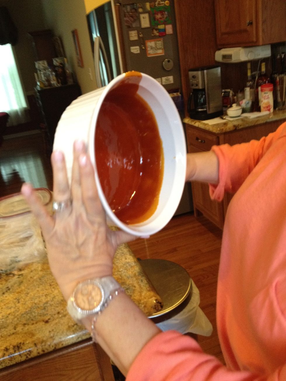 While the sugar is hot quickly coat the sides of the dish with the sugar before it hardens