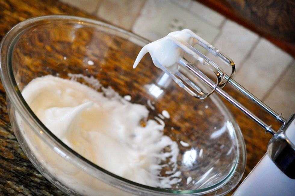 While the sugar syrup cooks, beat the two egg whites in a clean glass or metal bowl until they form medium-stiff peaks.