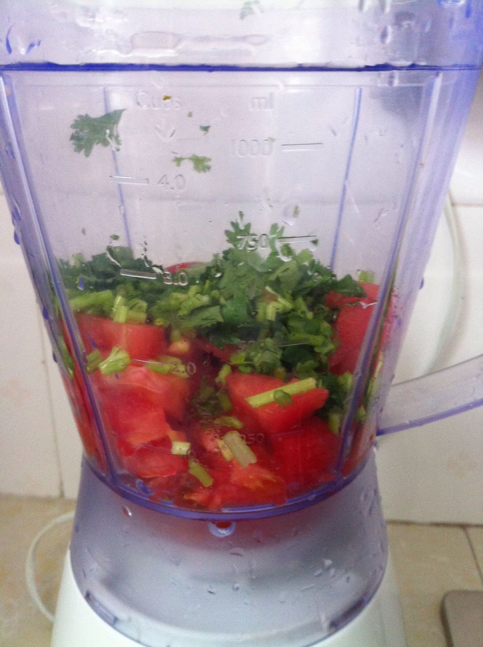 While the veggetables are baking, peel the skin from a tomato. U can do it over the gas flame, using boiling water or a sharp knife. Put into the blender,add some olive oil and blend it (with herbs).