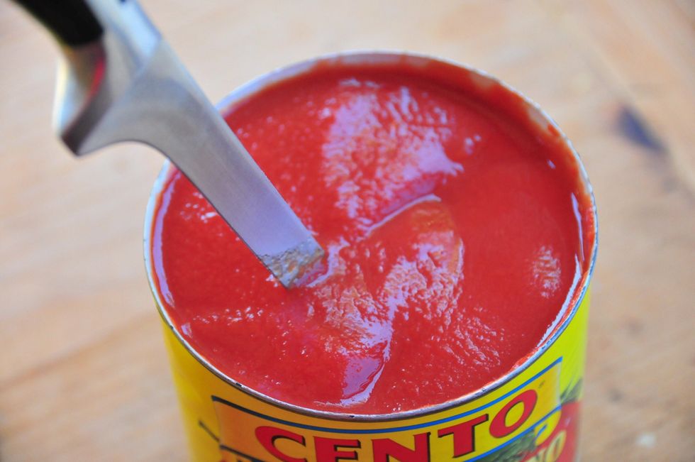 While the veggies are saut\u00e9ing down, open the tomatoes then take a sharp knife and gently cut up the whole tomatoes.  A lot easier and cleaner.