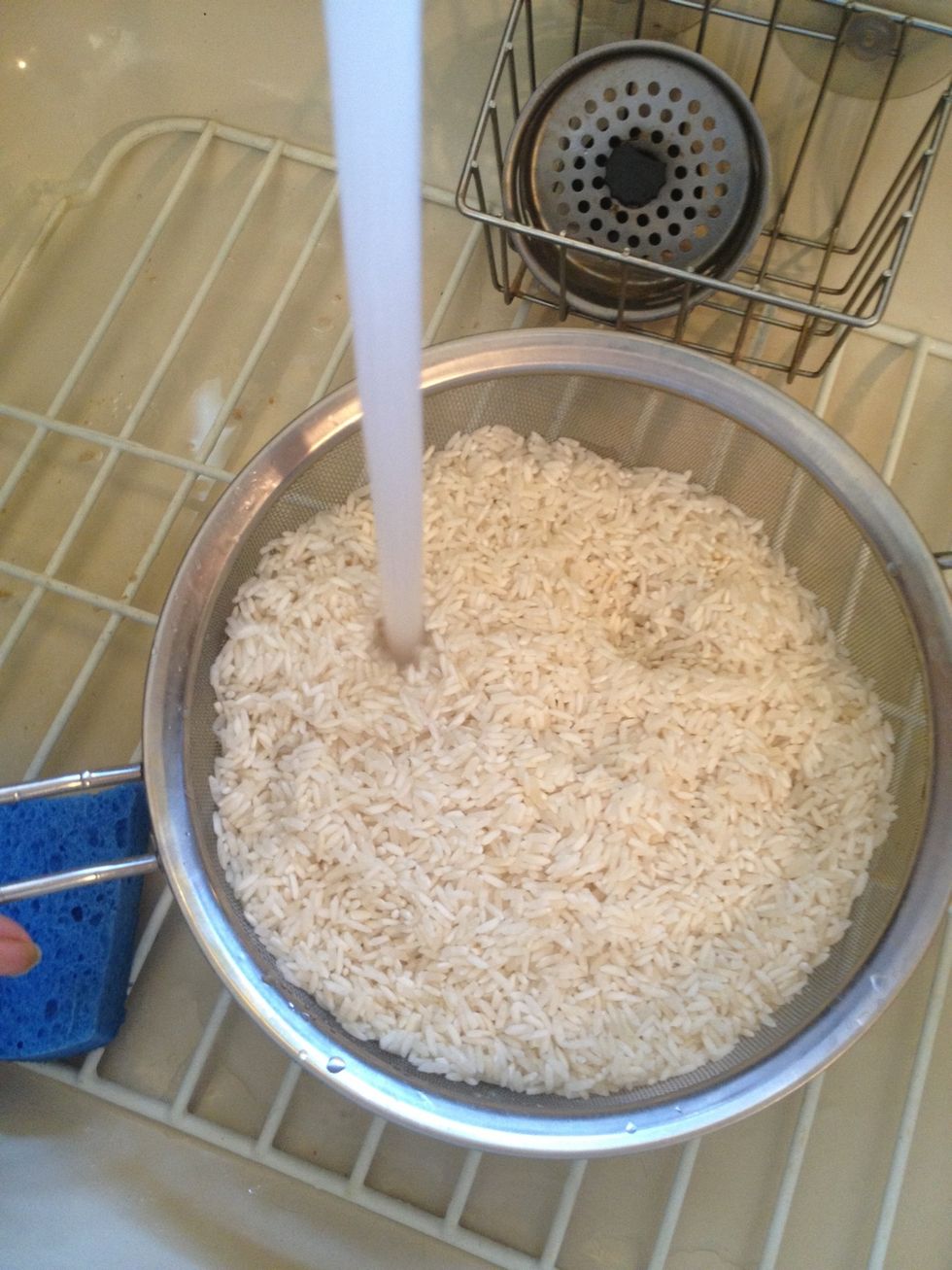 While the water comes to a boil take your rice and rinse it a few times under running water. Set aside.