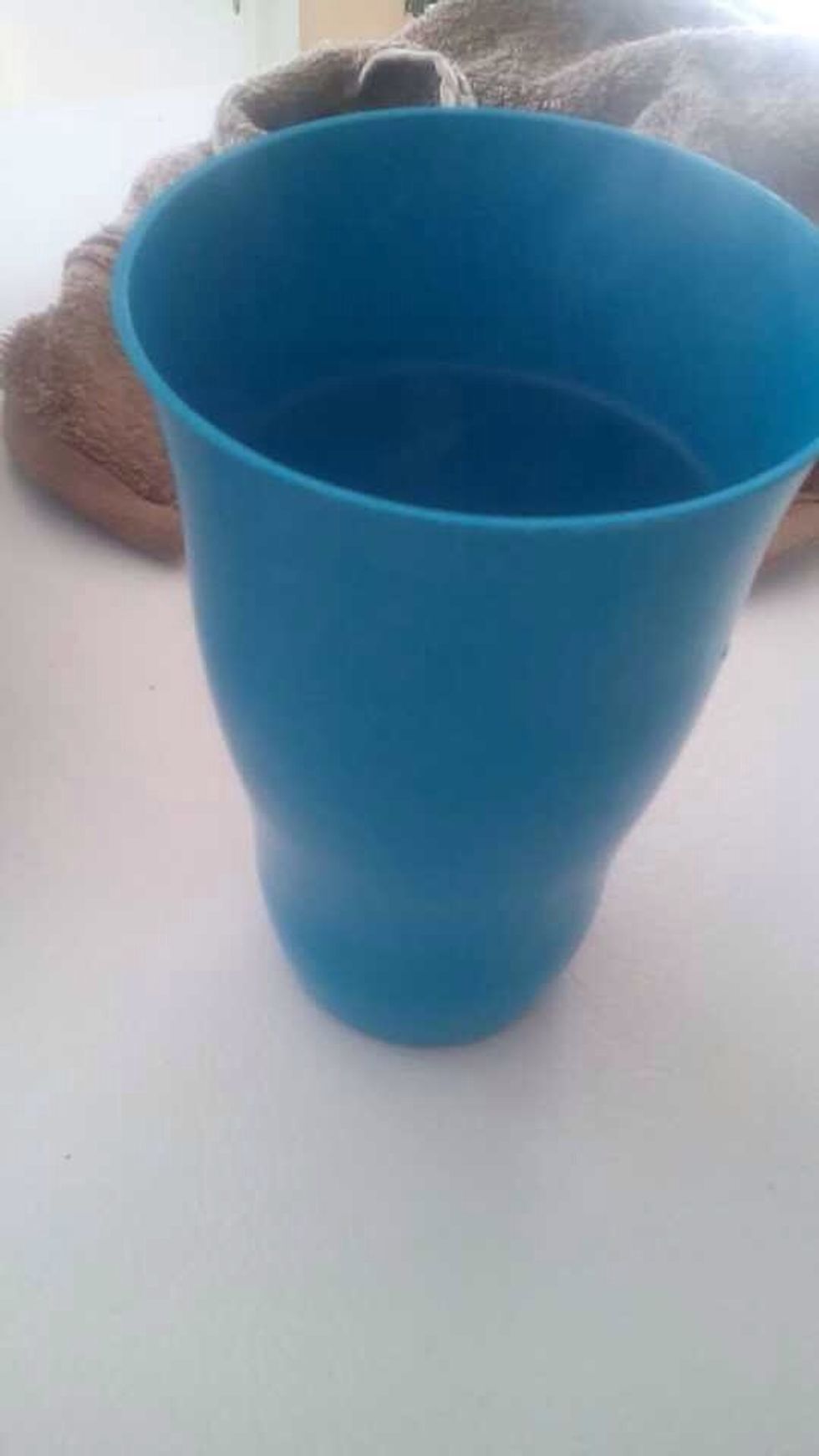 While the water is boiling, take your cup and pour your hot water in it. Do not turn the stove off.