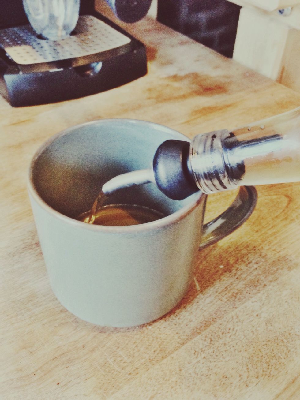 While waiting for green light pour any desired syrup (almond, vanilla, etc) into coffee mug. Mug should be at least 14-16oz. -- If you'd like to know more, request a flavored simple syrup recipe.