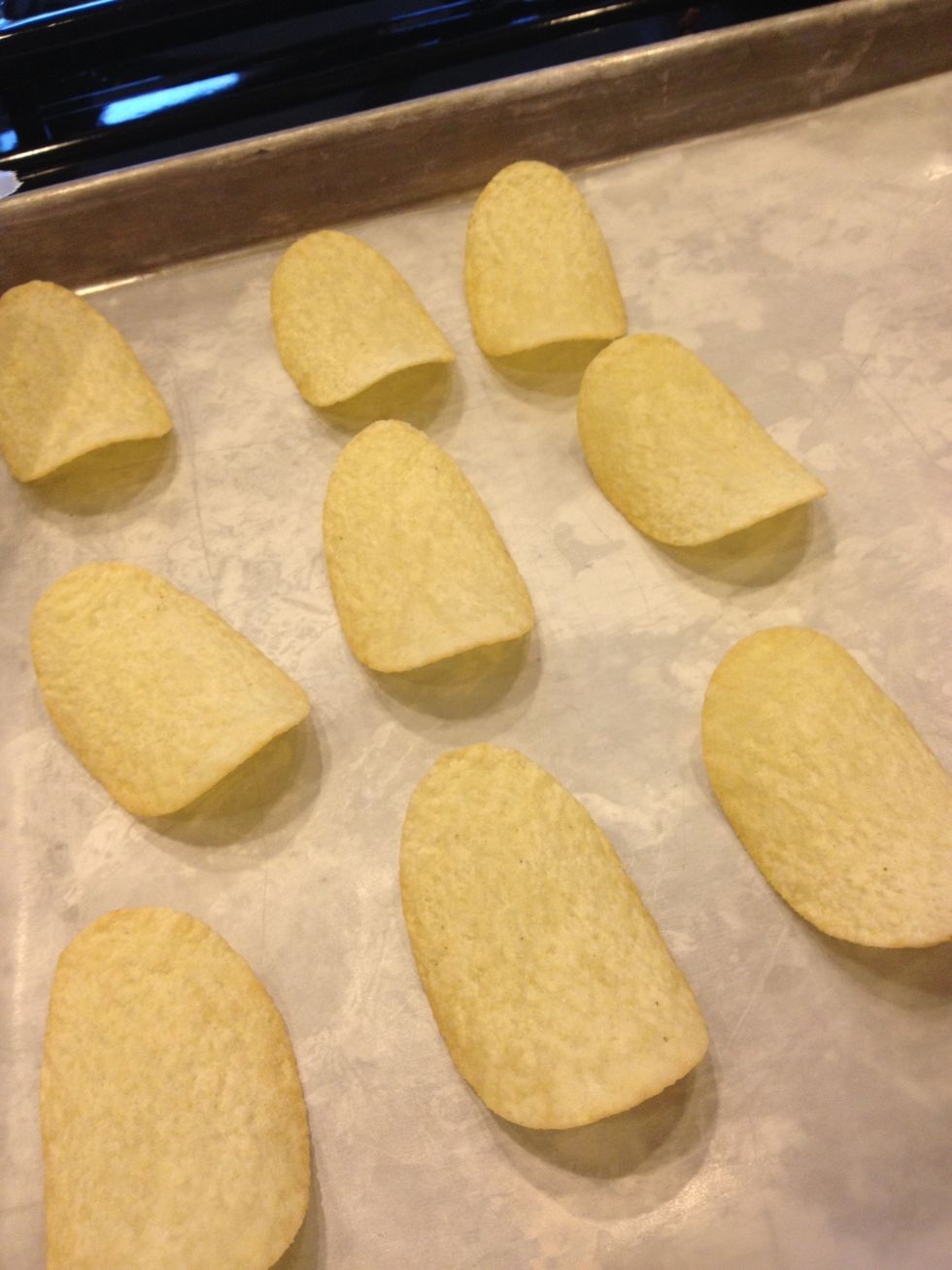 While waiting for the chocolate to melt put the potato chips on the cookie sheet