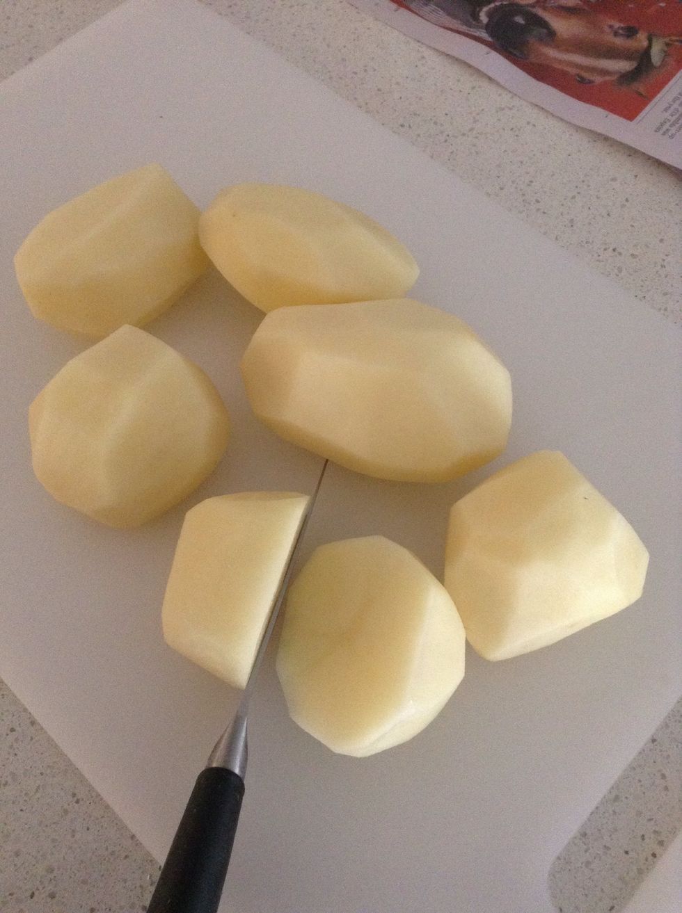 While waiting for the water to boil peel the potatoes and cut them in half. Always do a few more potatoes than you think as they get smaller after cooked!