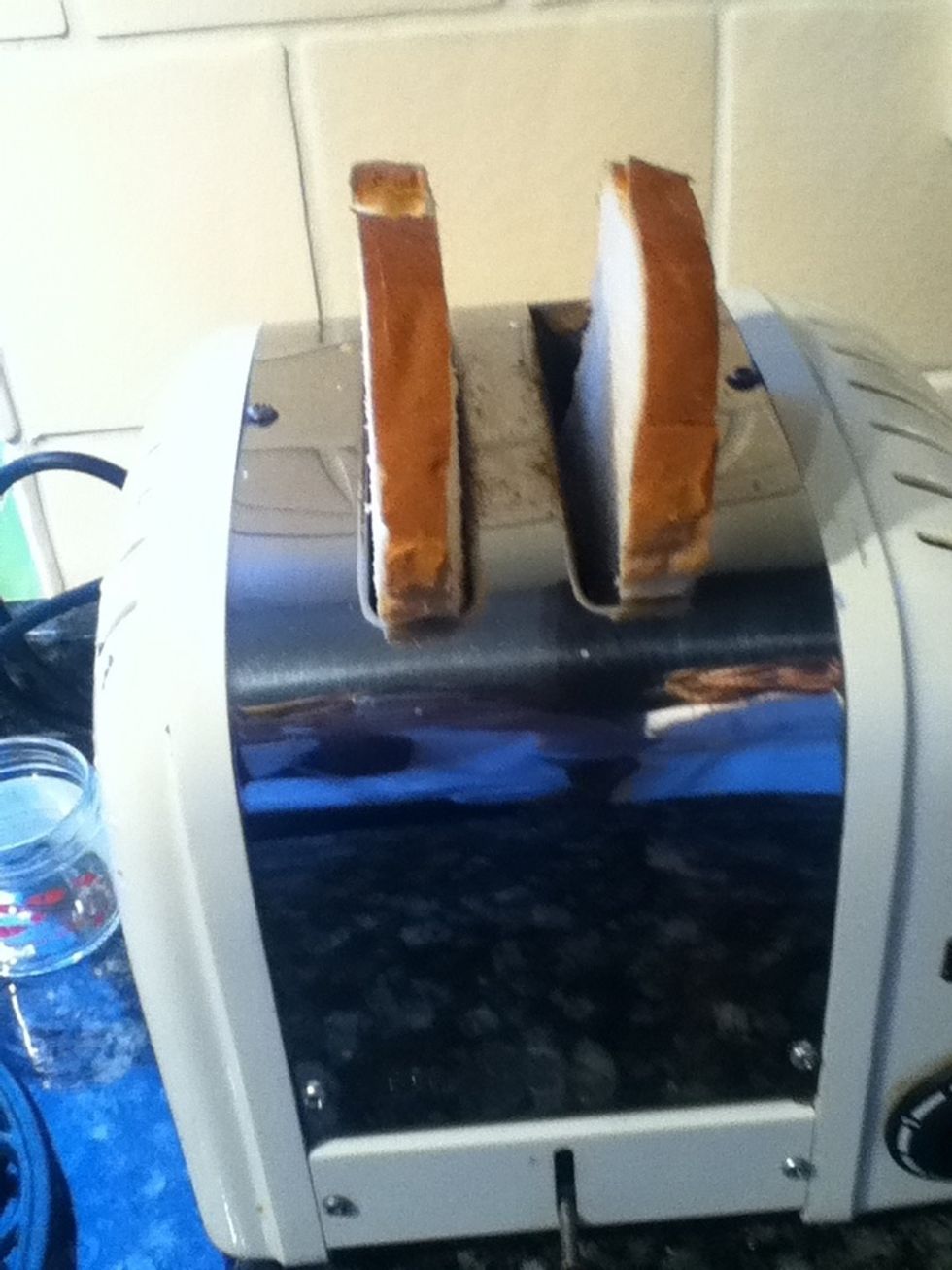 While waiting for your beans to bubble, put your two slices of bread you cut, in your toaster and toast for two minuets.