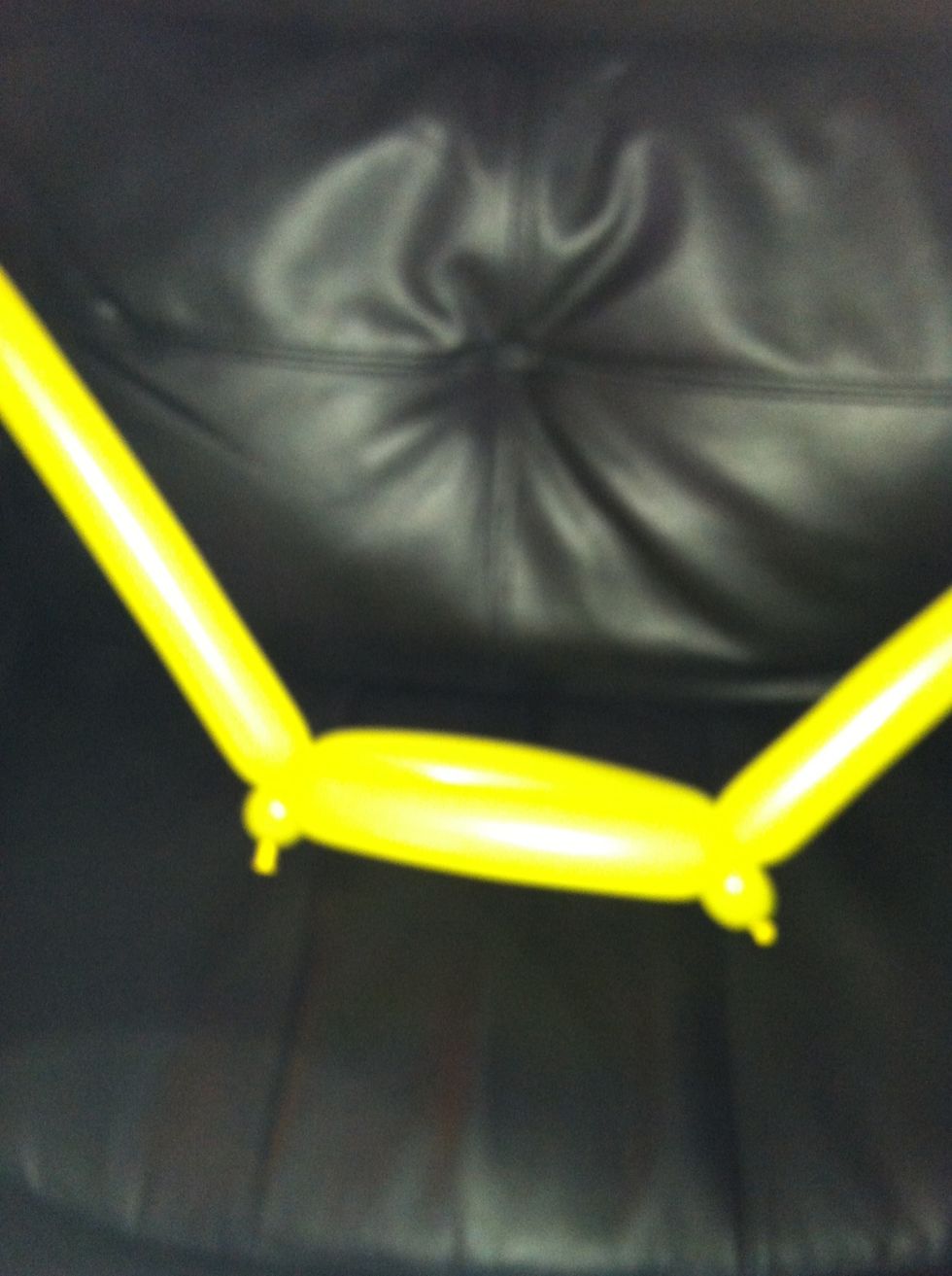 While you are controlling the small bubbles, twist a 5" bubble and attach one small bubble to the longer bubble of the second balloon. Repeat from the other side