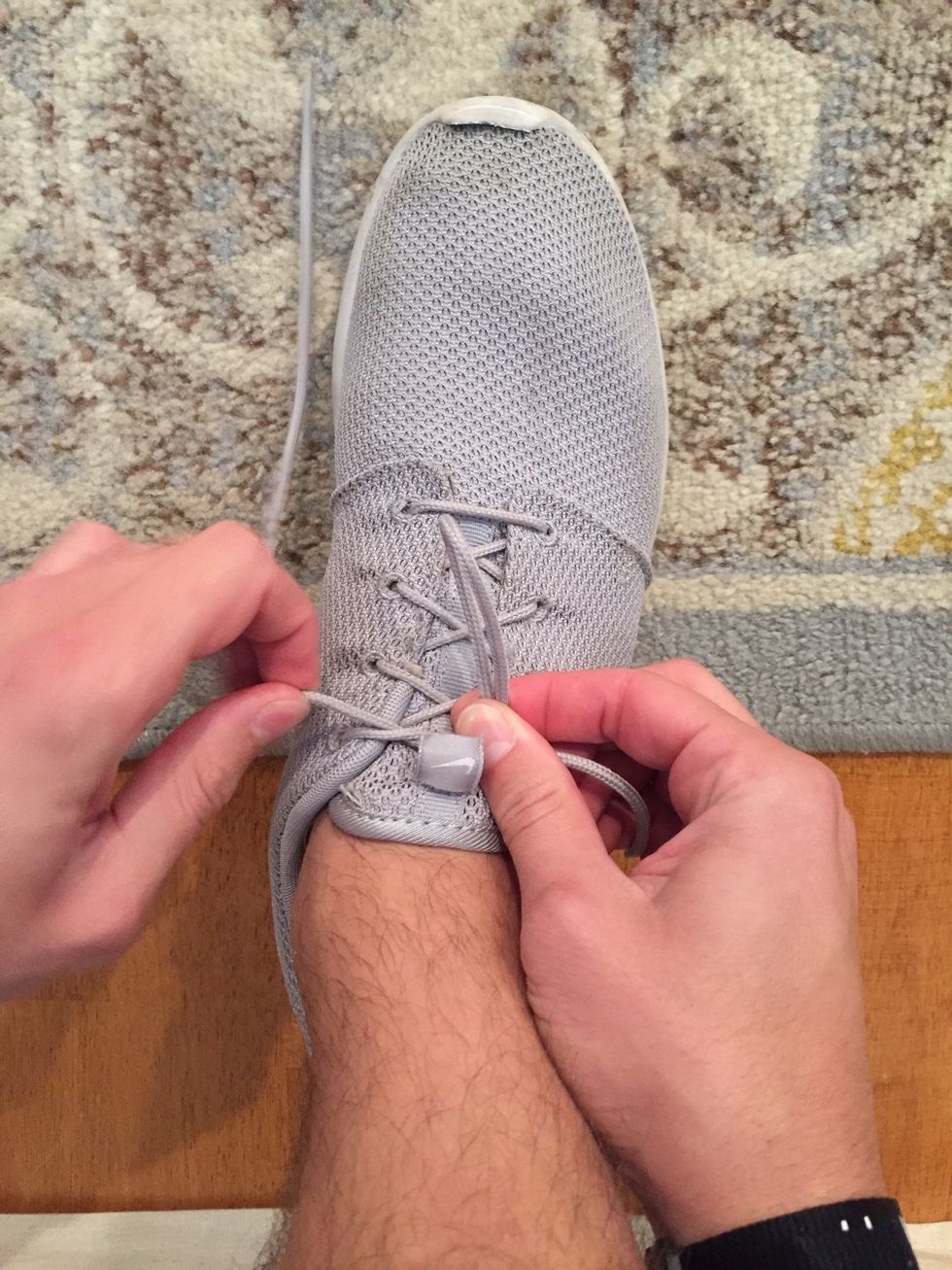 While you are pinching the "loop" hold down the "crossed over" section with the same two fingers. Begin to adjust your left hand in order to make the second "loop"
