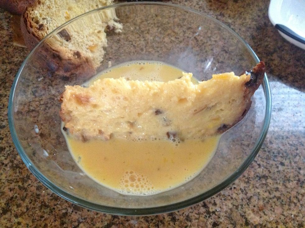 While you are waiting for the butter to melt, dip the sliced bread in the egg mixture. Make sure all sides are covered. Drip off excess egg mixture before putting the bread in the pan.