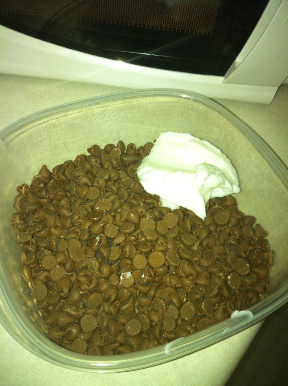 While you are waiting for the peanut butter to cool, combine the chocolate chips and vegetable shortening in a microwaveable container.