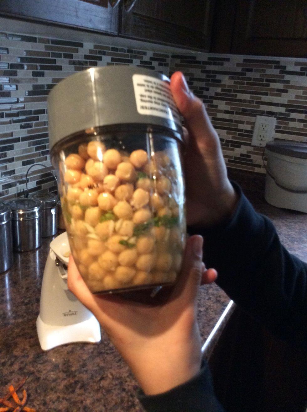 While your carrot chips are cooling down, pour your chick peas and spices that you have added to the mix in a blender and blend it until the dip is thick , rich and creamy.