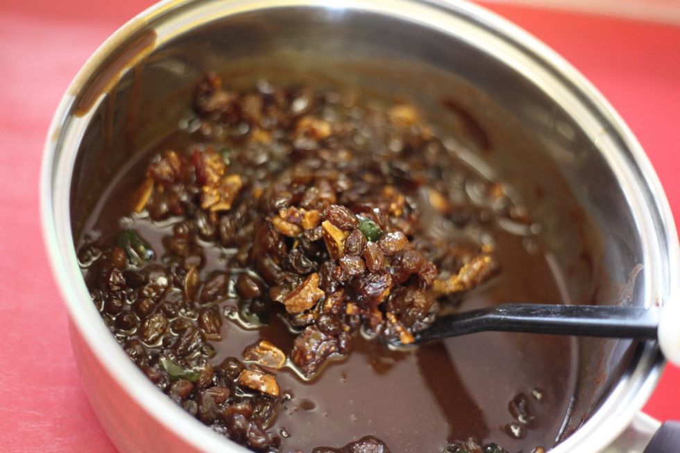 While your chocolate is still hot, add the bowl of chopped nuts, dates, sultanas, glazed cherries, walnuts, dried figs into the choc and stir thoroughly.
