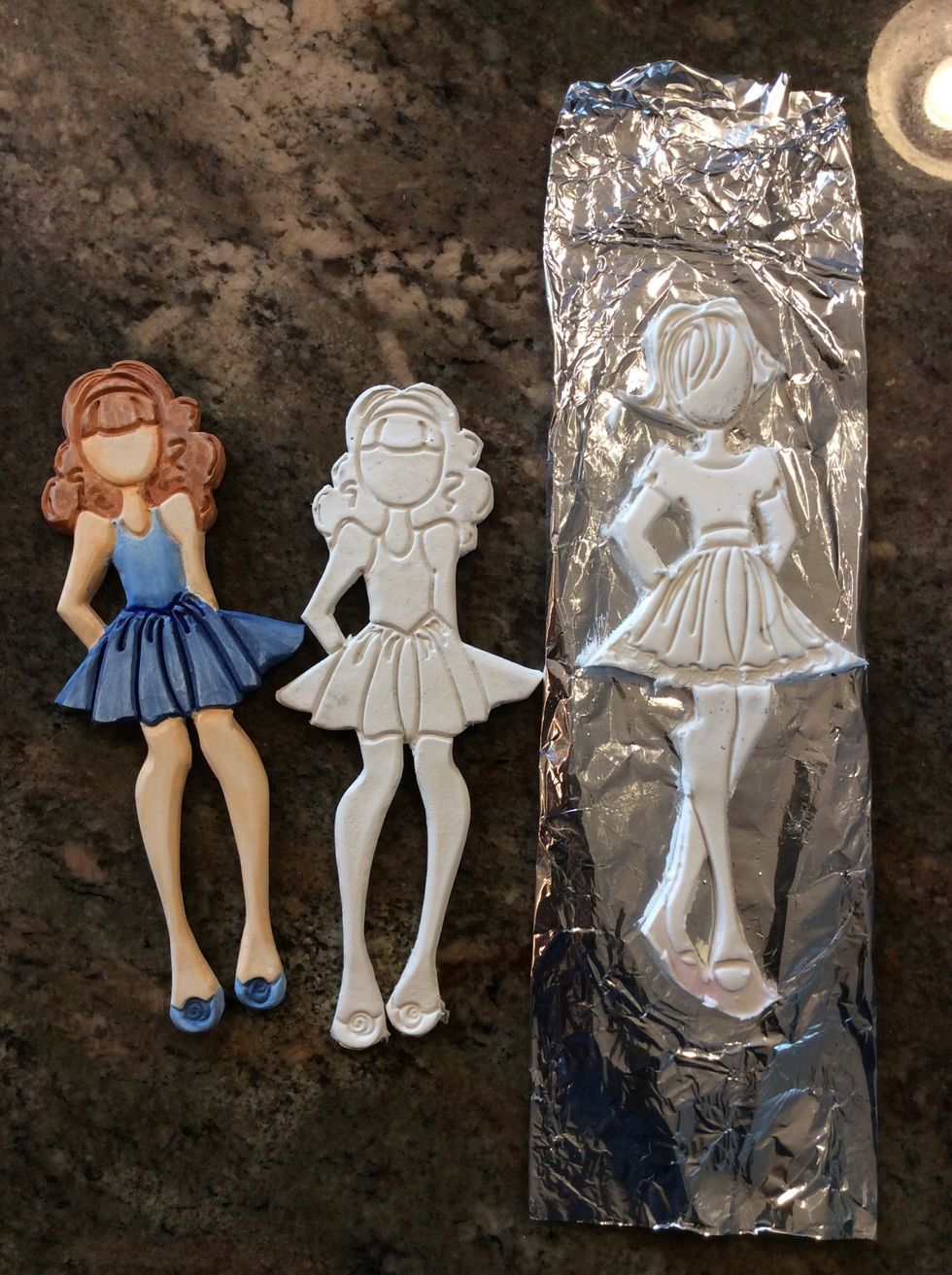 While your clay is wet, you can add a hook. Let dry overnight or for approx. 1 hour in a 300 degree oven. Once dry, you can sand ( I use an Emory board), and color/ paint it.