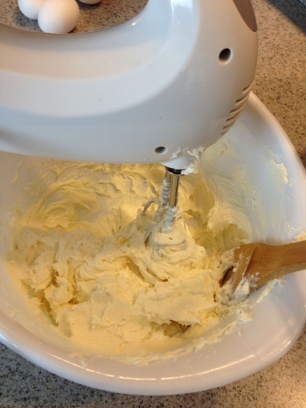 While your crust is cooling. Work on the filling. Mix your cream cheese, sugar, vanilla extract, freshly squeezed lemon. Then add 1 egg at a time. I use one egg for every 8 ounces of cream cheese.