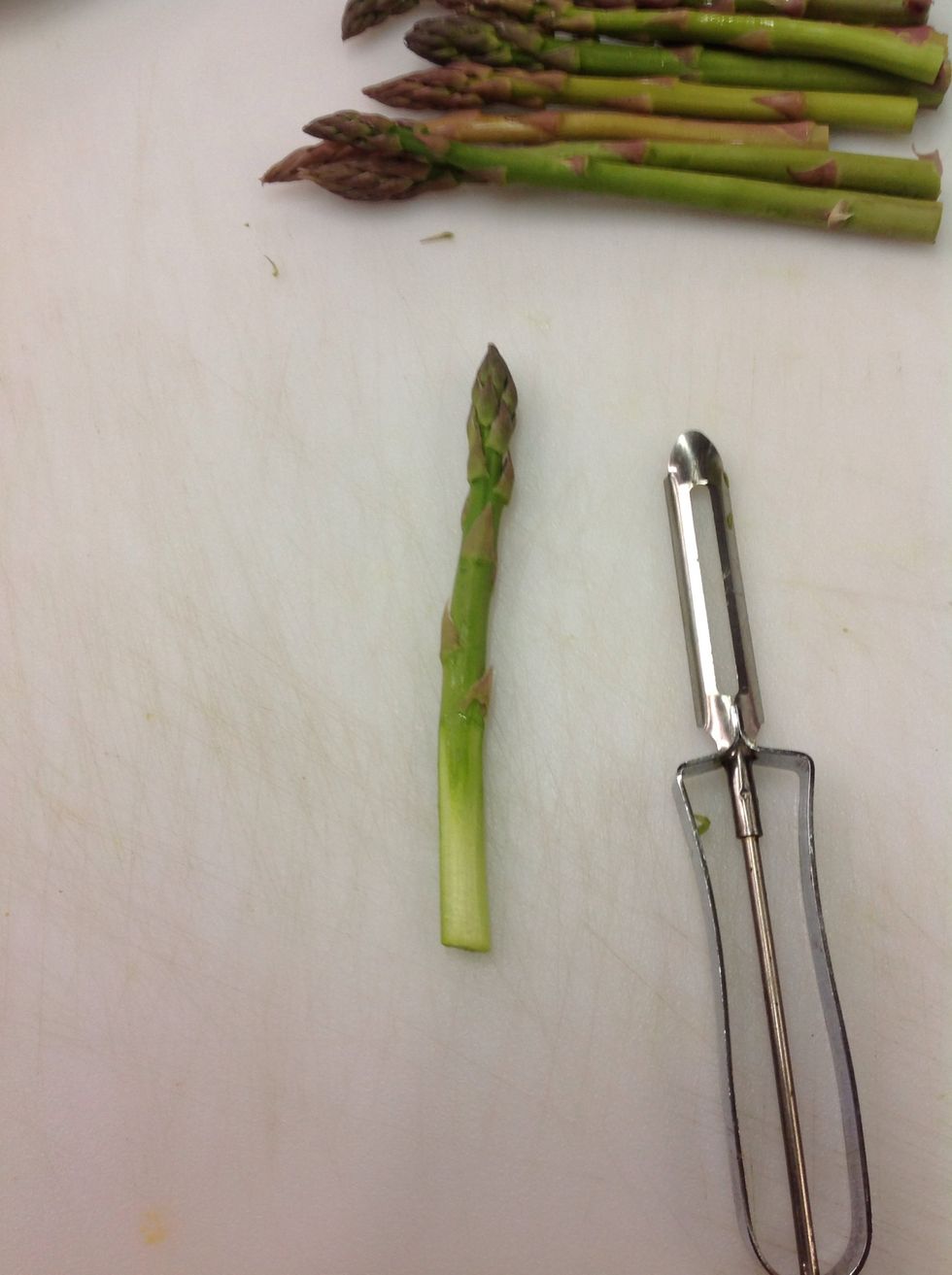 While your eggs are cooking, peel your asparagus.