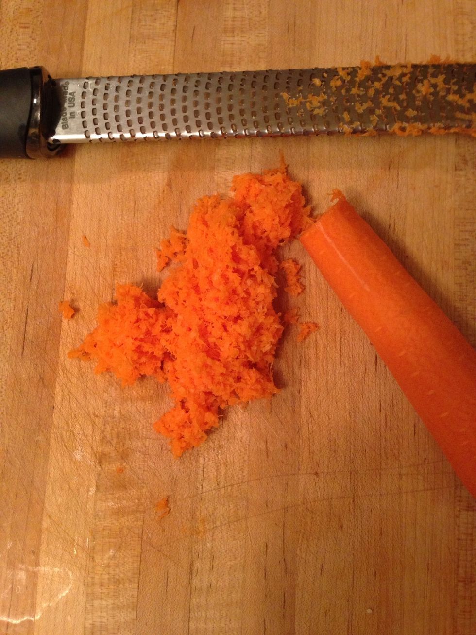 While your onions and garlic are softening grate half a carrot.