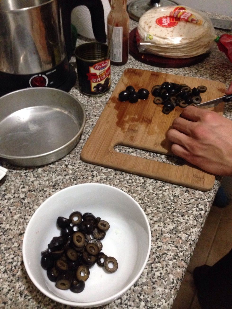While your your ground beef is simmering, or after it's done, you can start working on slicing your olives. You can buy pre-sliced ones as well.