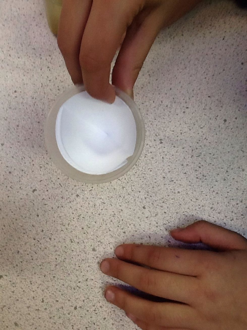 Whilst keeping your paper in a cup shape place it inside of the funnel