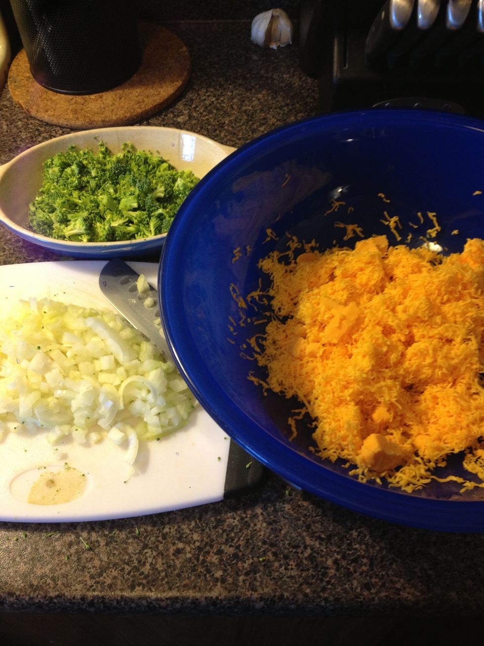 Whilst macaroni is boiling, finely dice onions and broccoli& grate cheese.