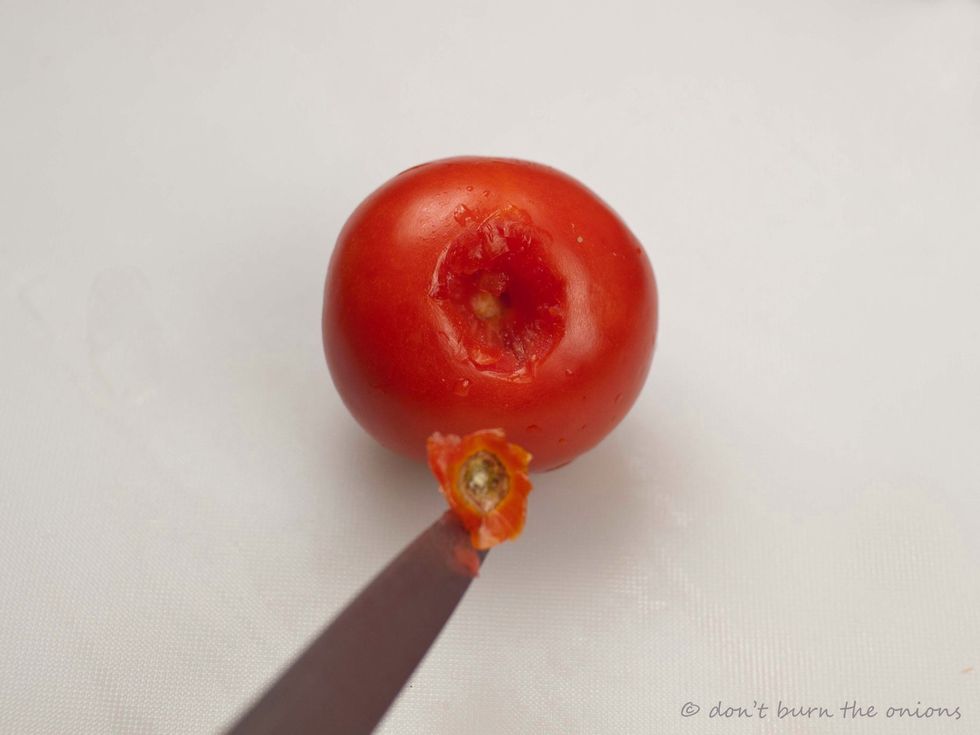 Whilst other vegetables are cooking, prepare to skin the washed tomatoes by using the following quick method. First remove the "eyes" using a sharp pointed knife.