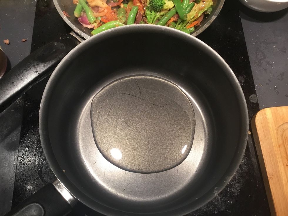 Whilst the veggies are still frying, get a large pot and add enough oil to cover the base.