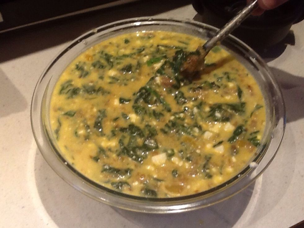 Whip egg mixture while adding onion spinach mixture.