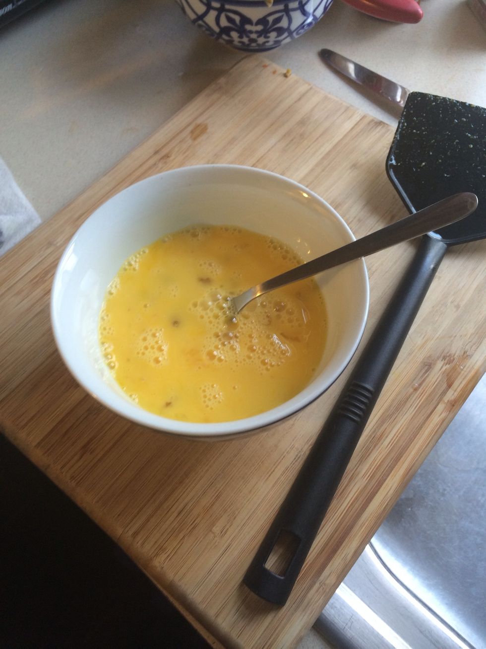 Whip eggs and pour into chicken while it is cooking