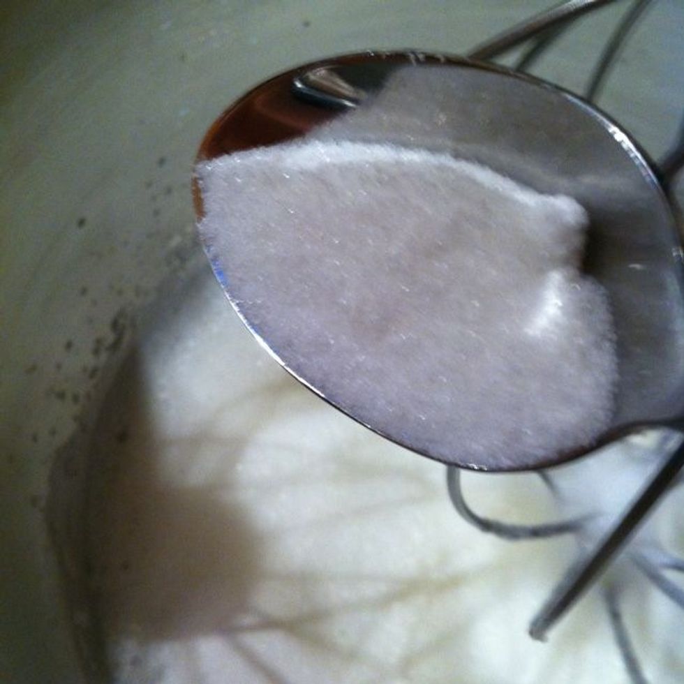 Whip in a half cup of the sugar, 1 tablespoon at a time. Continue to whip the whites until they are stiff but not dry.