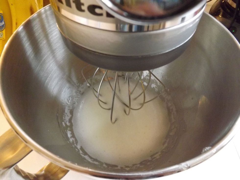 Whip the egg whites and creme of tarter on medium speed till it reaches soft peaks.