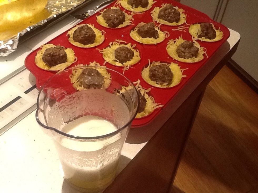 Whip the egg whites and spoon some in each cup.