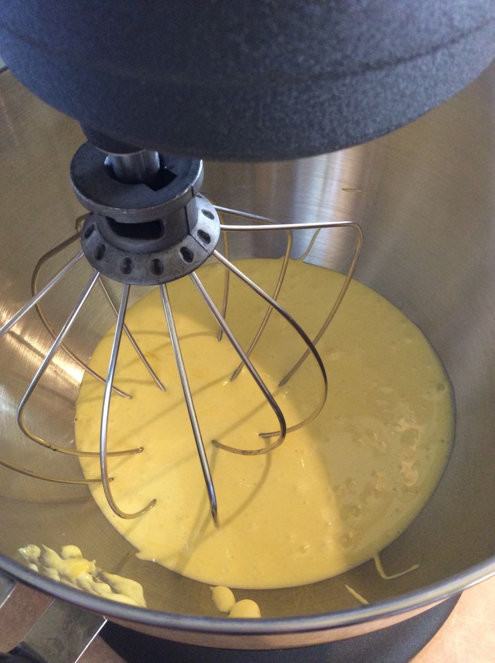 Whip the sugared egg yolks in a stand mixer. Whip until thick and cool.