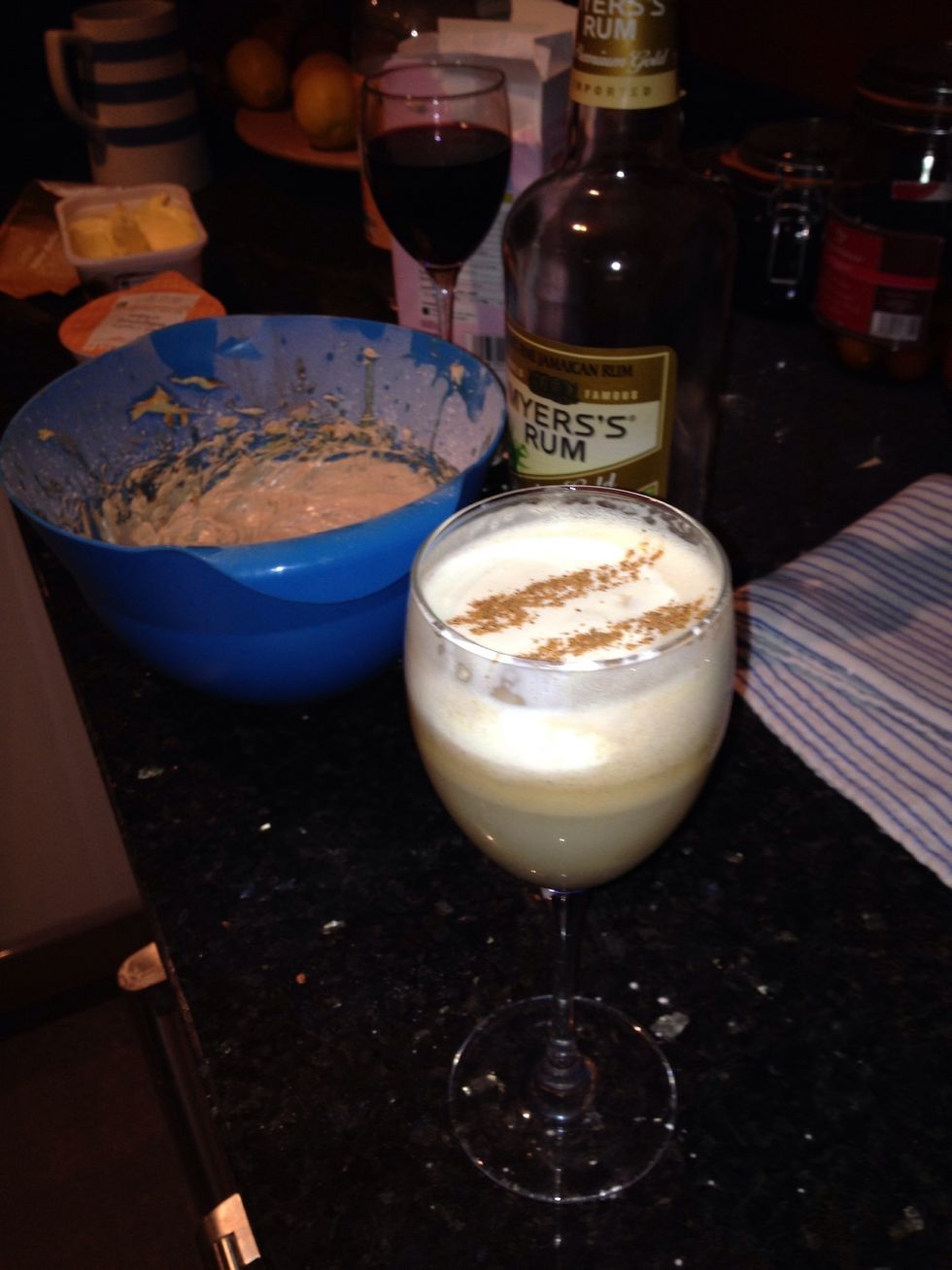 Whip up some whipping cream by hand. Pour into glass over the back of a bar spoon. Grate fresh nutmeg over the top. Et voila!! Un tres Bon hot buttered rum!