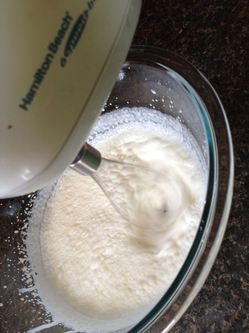 Whip with a whisk attachment, starting on low, increasing speed as it thickens. Move the beater around the bowl.