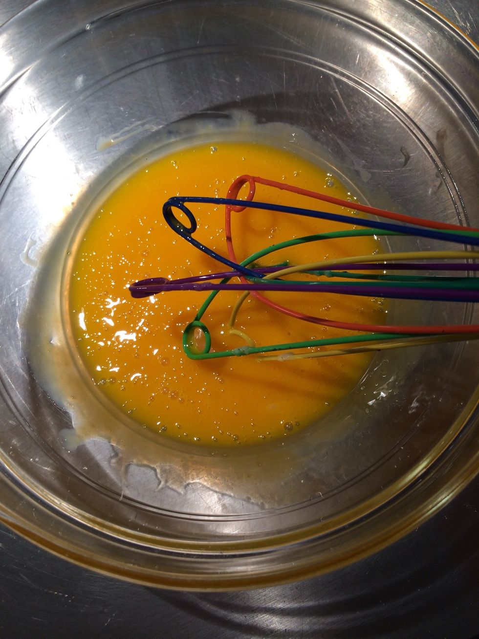Whisk but don't beat. It is to avoid incorporating air. Put the cream back on the fire and when it boils pour it slowly over the egg yolks while whisking.