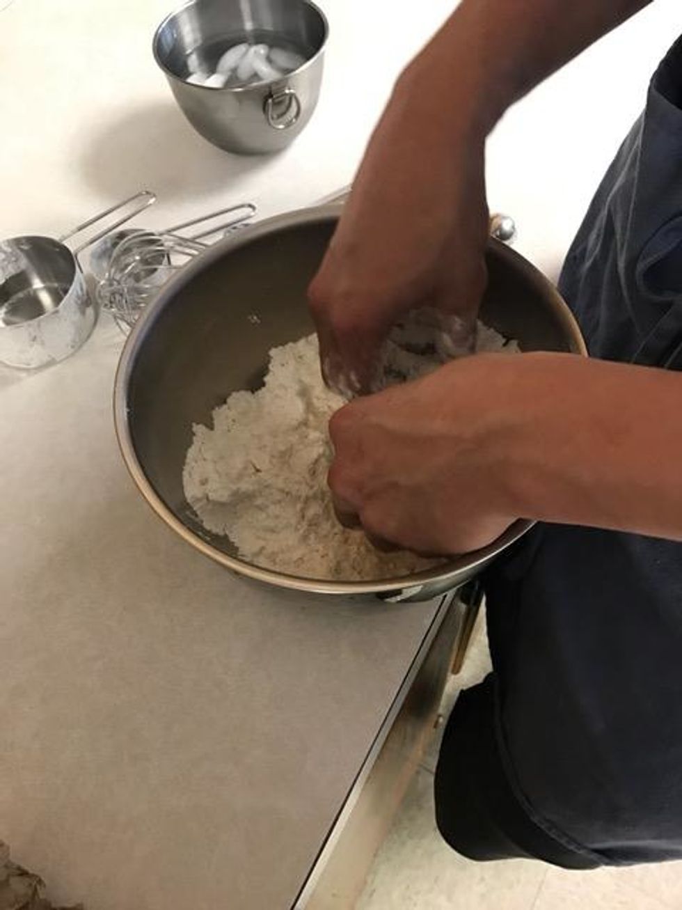 Whisk flour, flour, sugar, and salt in large mixing bowl. Then, add butter and rub in with fingertips until small pea-size clumps form.