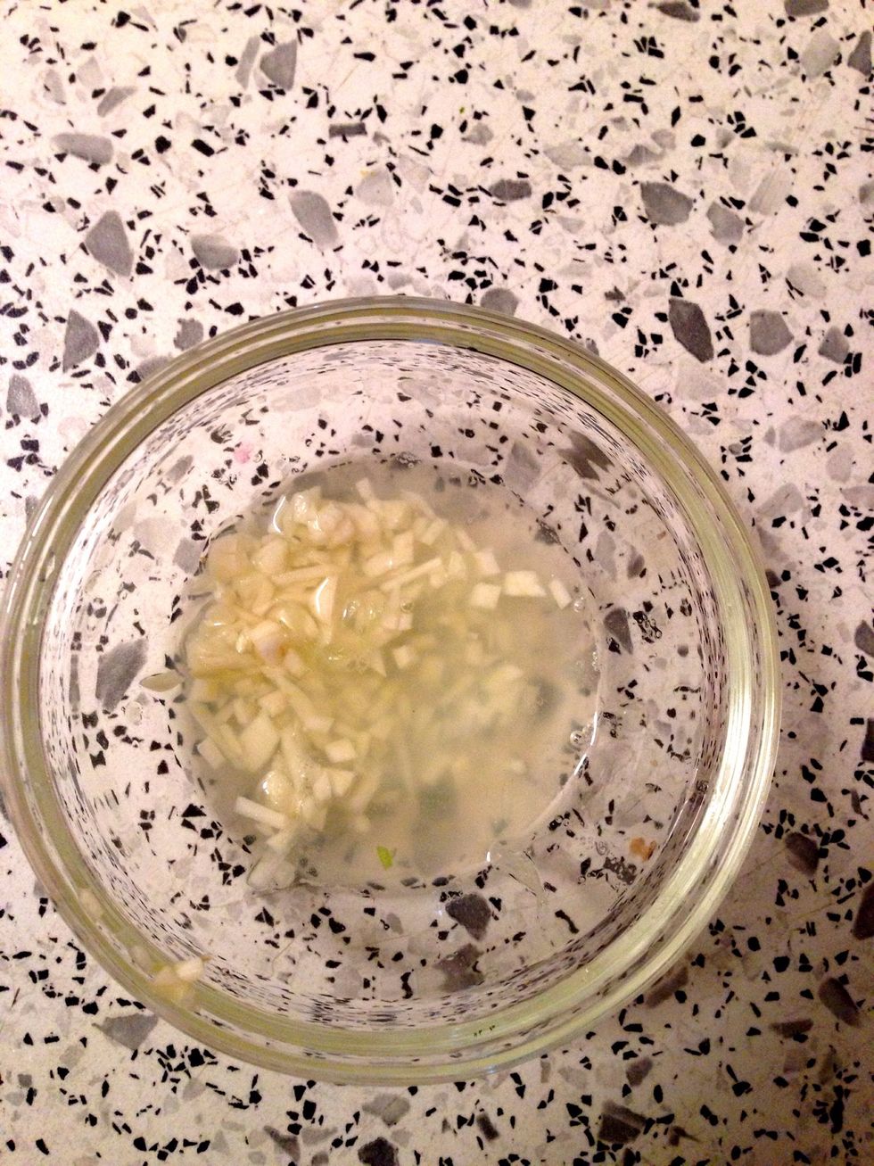 Whisk minced garlic and lime juice in a small bowl.