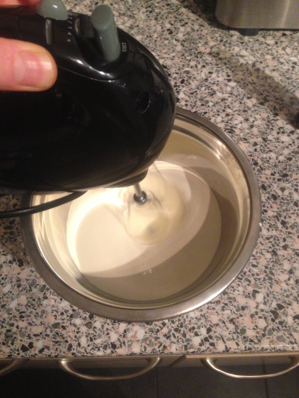 Whisk the cream until it becomes firm or "stiff peaks" this may take some time if you don't have an electric whisk.