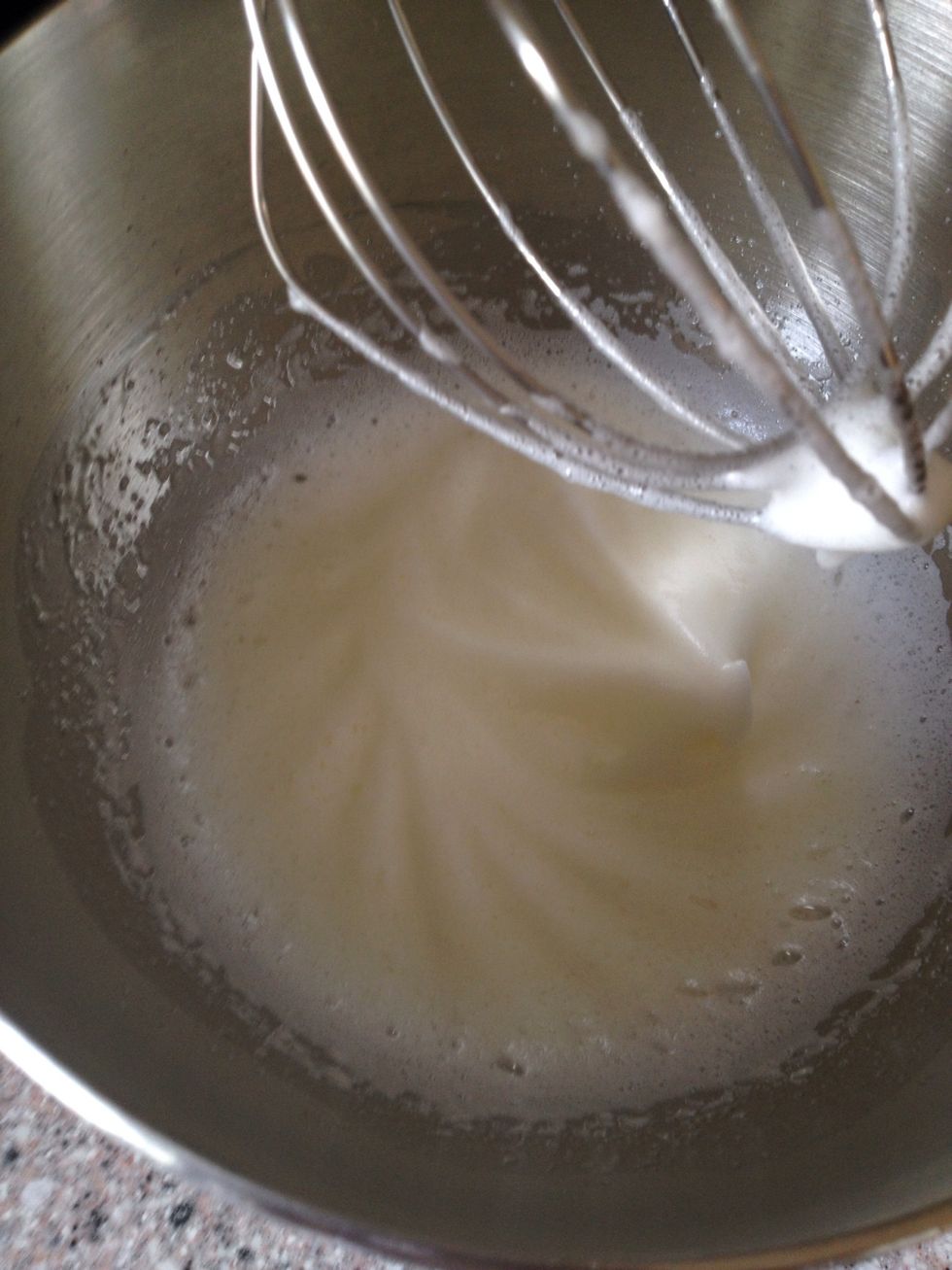 Whisk the egg whites until soft peaks. If you want to add vanilla, wait until solid peaks are formed, because even the small amount of oil in vanilla, will make it impossible to whisk the egg whites.